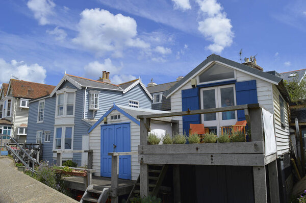 WHITSTABLE, UK-JULY 22: A row of traditional weather boarded houses along Whitstable sea front. Whitstable has been named as a property hot spot in 2017.. July 22, 2017 Whitstable, Kent, UK.