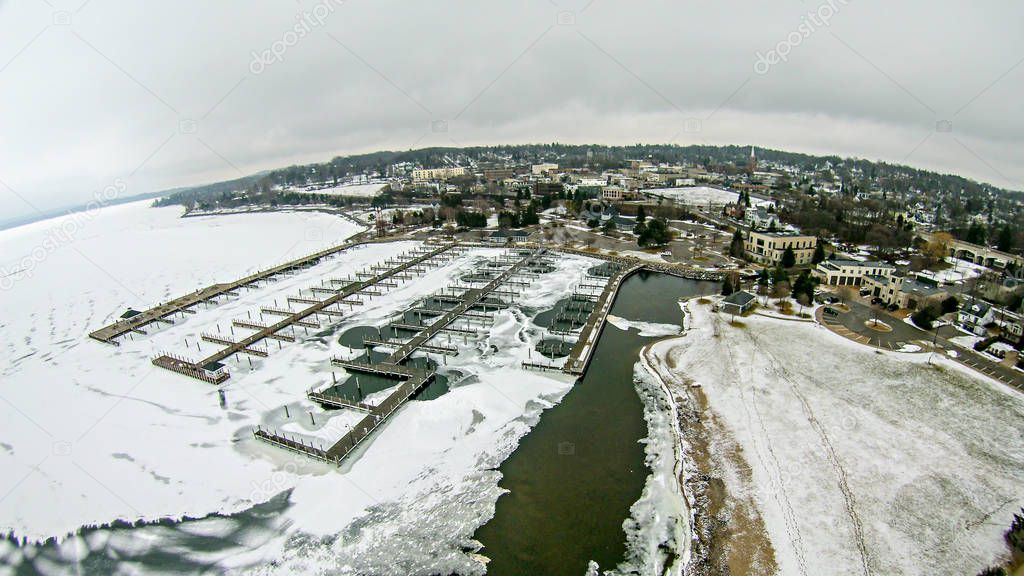 Petoskey Harbor Breakwater in spring with frozen lake 