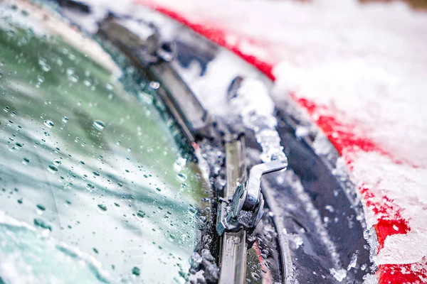 snow and ice covered windshield wipers