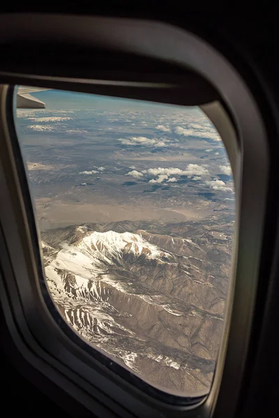 Flying over rocky mountains in spring at day time — Stock Photo, Image