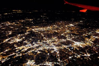 flying at night over cities below clipart