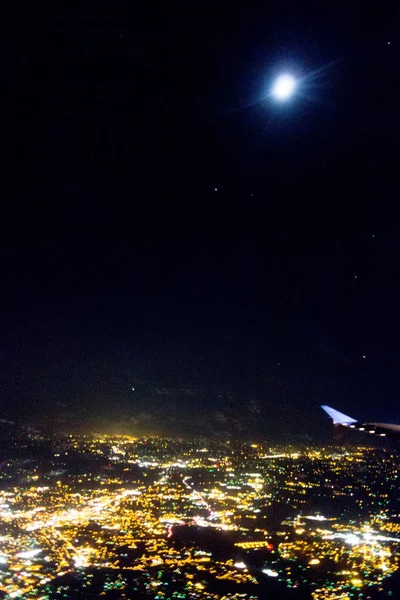 Flying at night over cities below — Stock Photo, Image