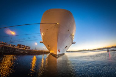 büyük kruvaziyer gemisi iskelede günbatımında demirli