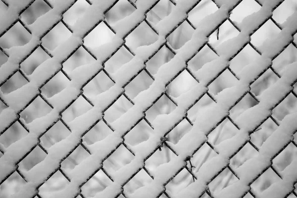 Snow stuck on chainlink fence enclosure after snow fall — Stock Photo, Image