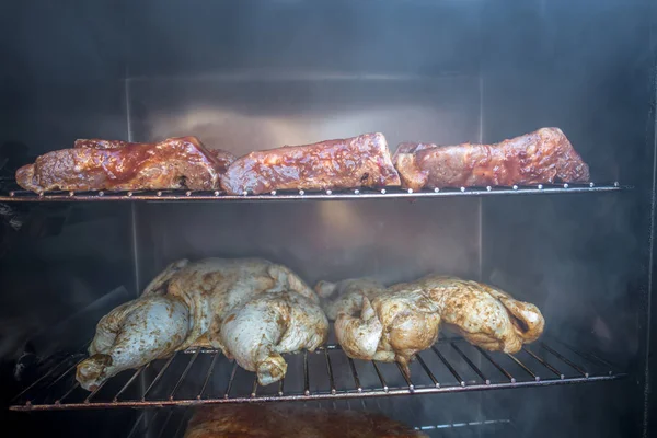 Electric smoker loaded with variety of meat — Stock Photo, Image