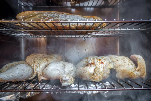 Electric smoker loaded with variety of meat — Stock Photo, Image