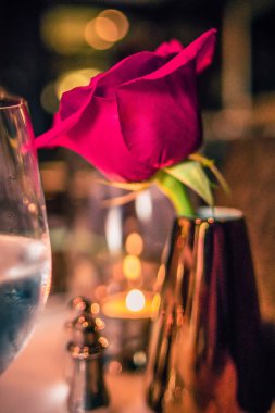 romantik bir akşam yemeği zaman kurulum tablosundaki bir gül