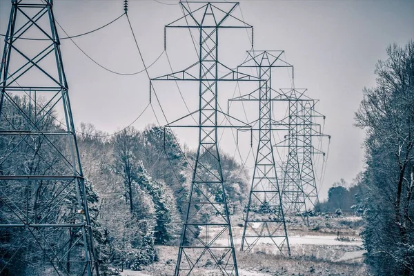 Snow covered valley and electric power grid lines — Stock Photo, Image