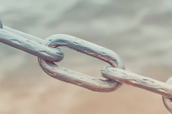 old metal chain links on a water background/old metal chain link