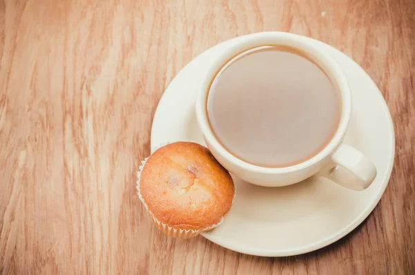 Muffin dengan cangkir kopi dengan latar belakang bertekstur kayu. Tampilan atas — Stok Foto