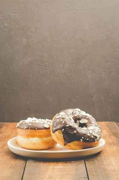 Doador. Donat em chocolate é espalhado com amêndoas raladas. Doador — Fotografia de Stock