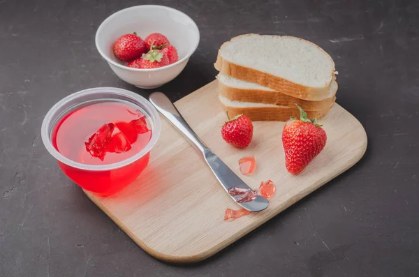 Strawberry pudding. Bread and strawberry pudding on a dark table