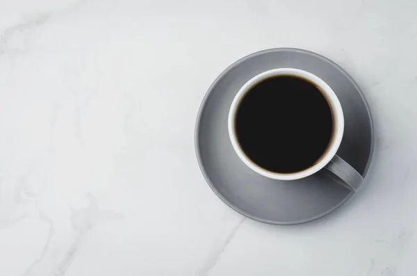 Gelas abu-abu dengan kopi hitam di latar belakang putih. Tampilan atas dan — Stok Foto