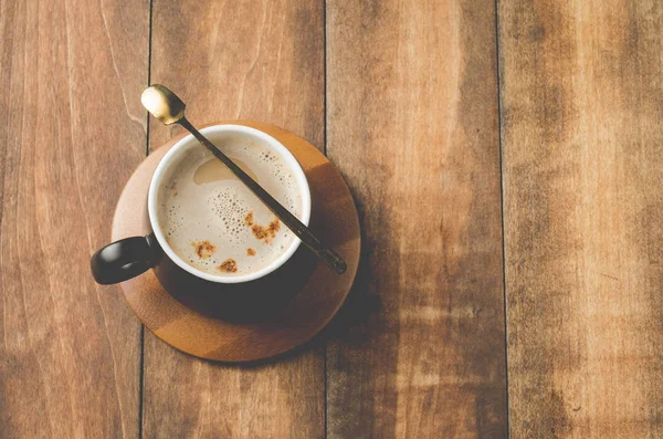 Mug Hitam Dari Cappuccino Dalam Dukungan Kayu Atas Meja Kayu — Stok Foto