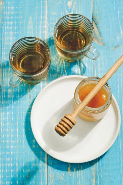 Bank Honey Dripping Spoon Plate Glass Cup Tea Blue Wooden — Stock Photo, Image