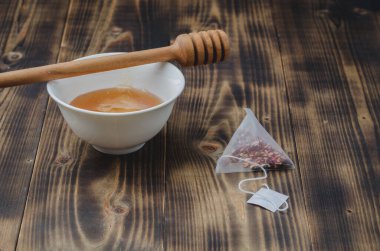 Ballı, çay poşetli, ahşap masa.