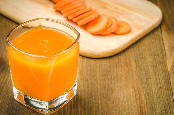 glasses fresh carrot juice ready for you/glasses fresh carrot juice ready for you on a wooden background. selective focus. copy space