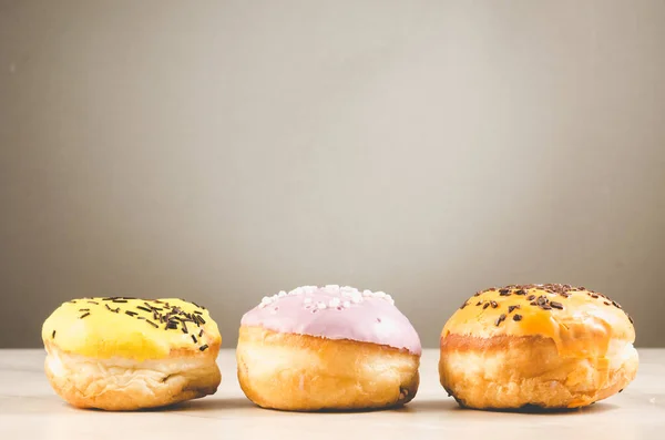 stock image Donuts. Assorted donuts lying on a white table on green background. Concept sweet food