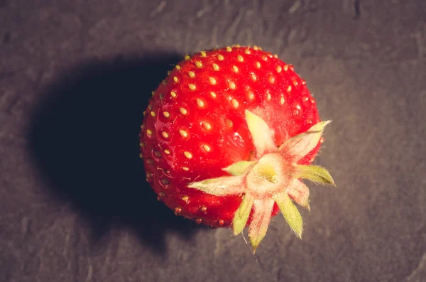 berry of strawberry on black background/Strawberry. Fresh berry of strawberry on black background. Top view