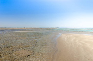 Mavi gökyüzü olan güzel deniz manzarası. Deniz ve güneşli gökyüzü üzerindeki boş yaz plajı.