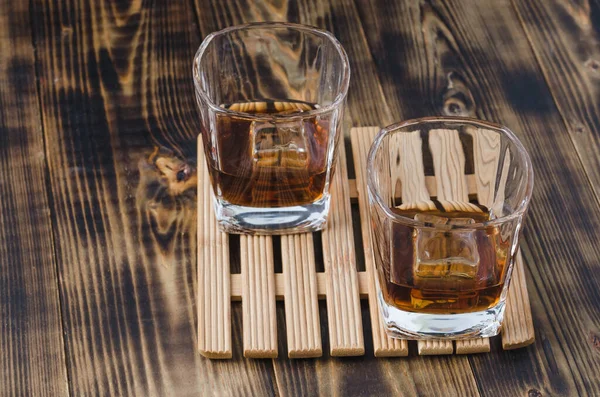 Two Glasses Cognac Ice Cubes Wooden Table Two Glasses Cognac — Stock Photo, Image