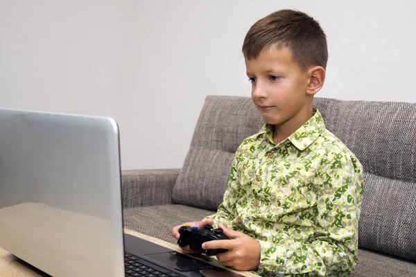 Cute boy playing video games at home — Stock Photo, Image