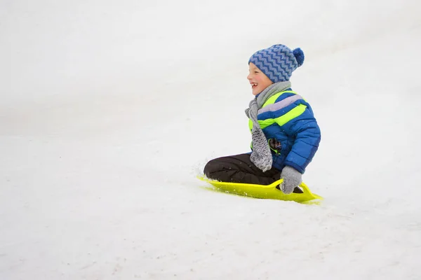 Small Boy Slides Hill Plate Driving Snow — Stock Photo, Image