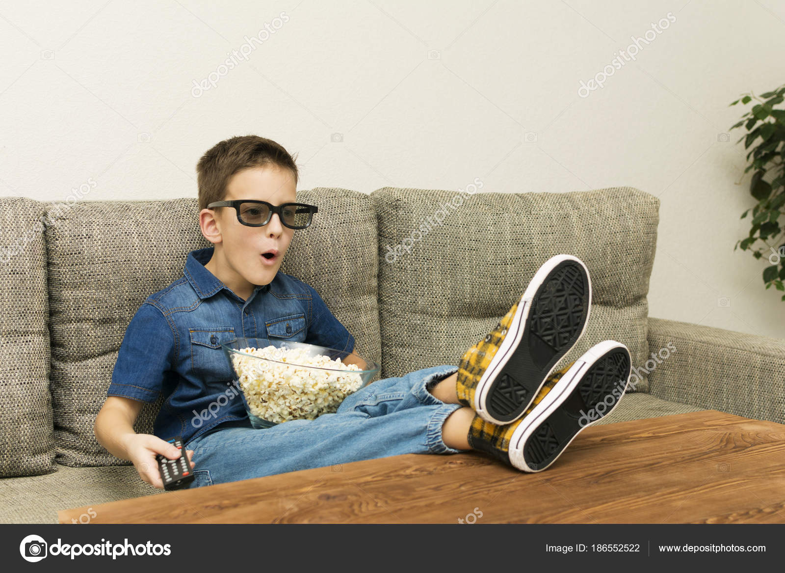 Fun Excited Boy In 3d Glasses Watching Tv With Popcorn And Remo Control In The Living Room Stock Photo C Alexytrener 186552522