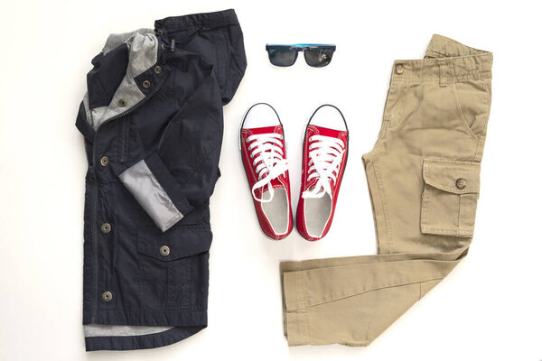 Top view fashion trendy look of teen clothes on white. Spring, autumn boy outfit set.