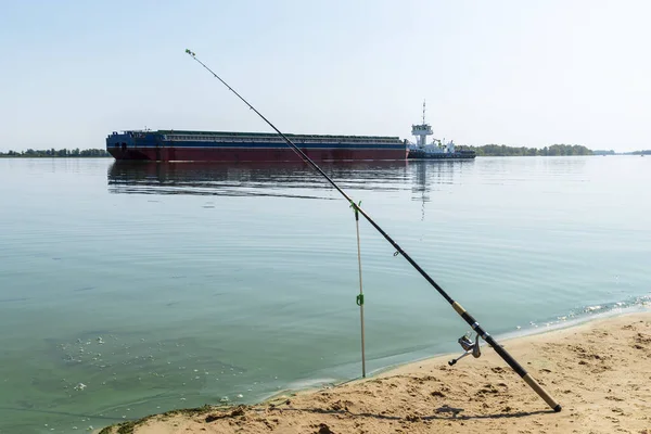 Caña de pescar contra la barcaza cisterna con grano en el río Dniepr Ucrania. Logística del agua — Foto de Stock