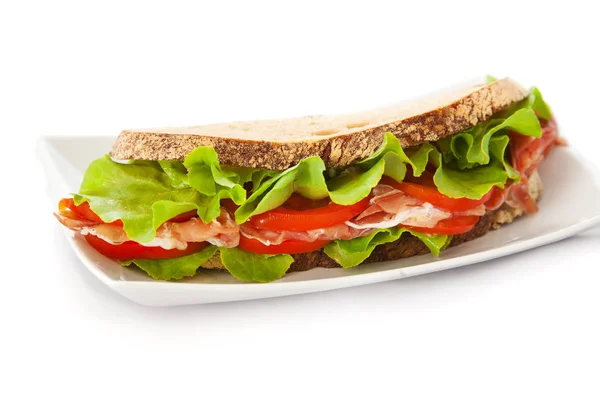 Sandwich with ham, tomatoes and salad — Stock Photo, Image