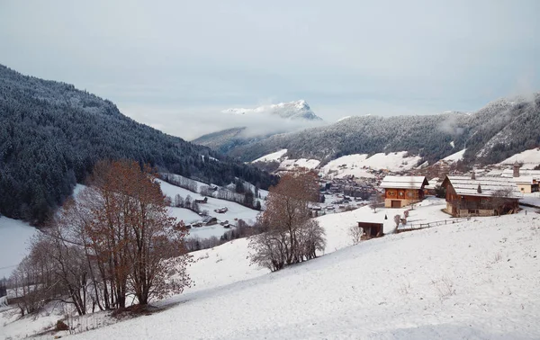 Scenic snowy winter Alpine landscape with cabin