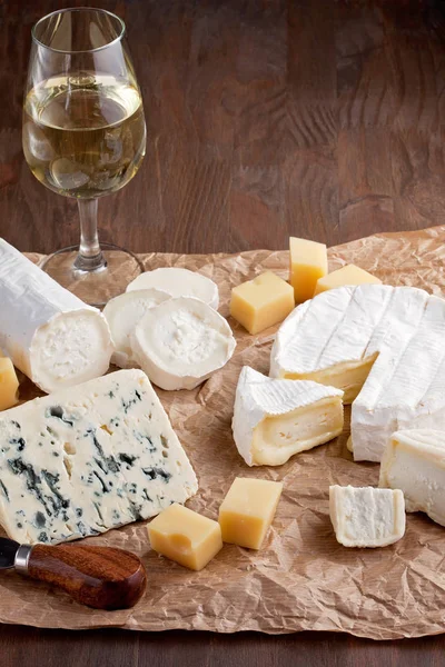 Variety of different cheese with wine. Camembert, goat cheese, roquefort, gorgonzolla, gauda,