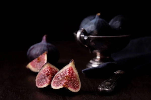 Ripe fresh figs on dark background