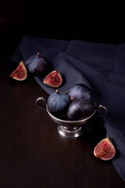 Ripe fresh figs on dark background