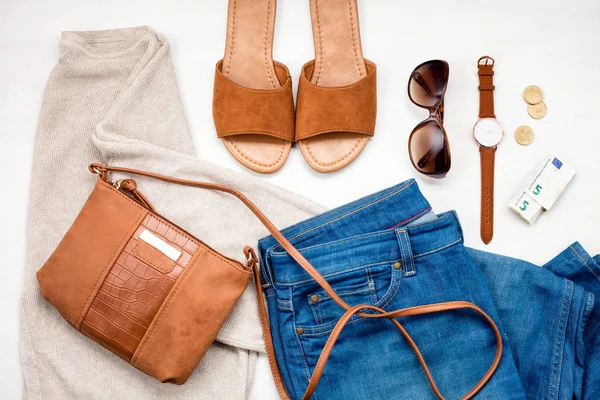 Summer street style. Fashion summer girl clothes set, accessories. Trendy sunglasses, slippers, handbag clutch,  watch, jeans. Summer lady. Creative urban overhead summer top view