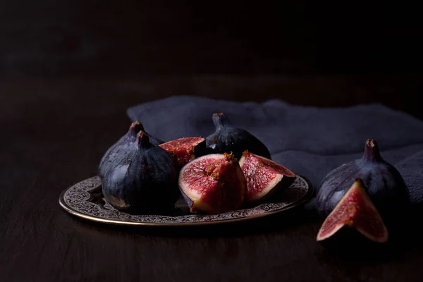 Ripe fresh figs on dark background