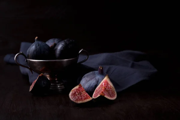 Ripe fresh figs on dark background