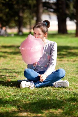 Genç Kız parkta pamuk şeker yemek
