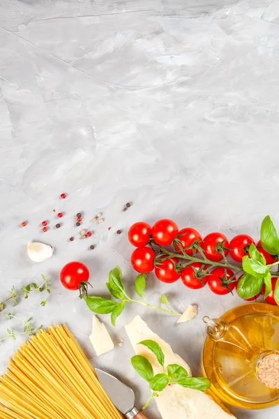 Bunch of fresh basil, tomatoes, parmesan cheese, garlic and olive oil - traditional ingredient of italian cuisine