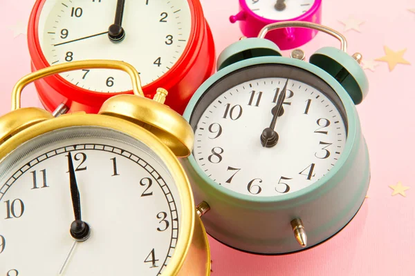 Collection of bright colorful alarm clocks over the pink background — ストック写真