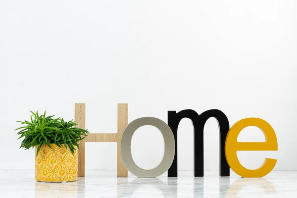 Table top with the word home, boxes for arrangement, starage, an — Stock Photo, Image