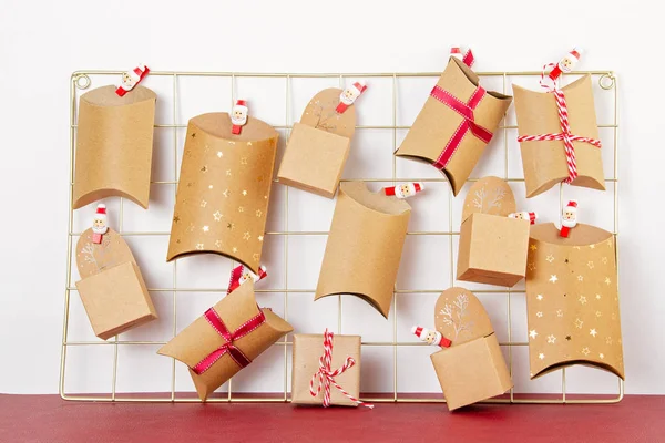 Advent calendar with craft carton boxes on the mesh board — Stock Photo, Image