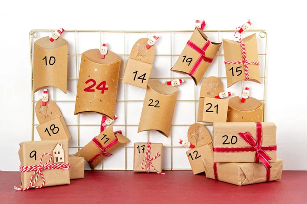 Advent calendar with craft carton boxes on the mesh board — Stock Photo, Image