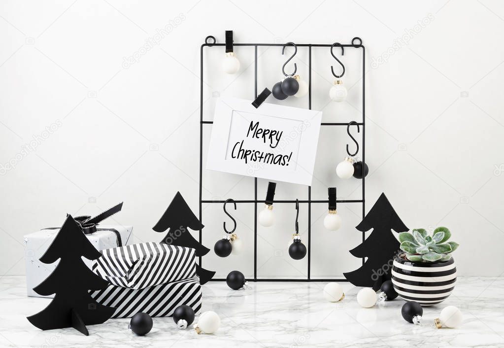 Trendy fashionable christmas decoration with gifts, greeting card and mesh board