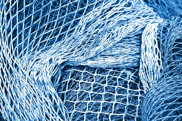 Abstract background with fishing net texture toned in blue monoc
