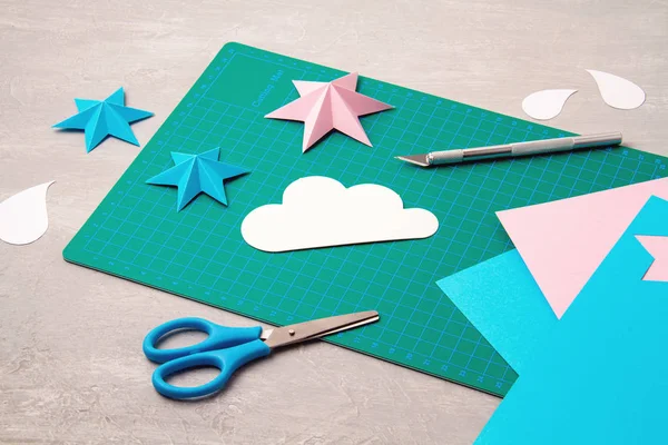 Top view over paper  cut tools, scissors, cutter, cutting mat, and crafted paper objects. DIY trendy project concept — 스톡 사진