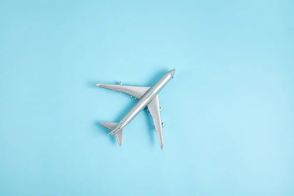 Miniature airplane. Travel tourism, airlines, low cost flights concept. Top view, flat lay. — Stock Photo, Image