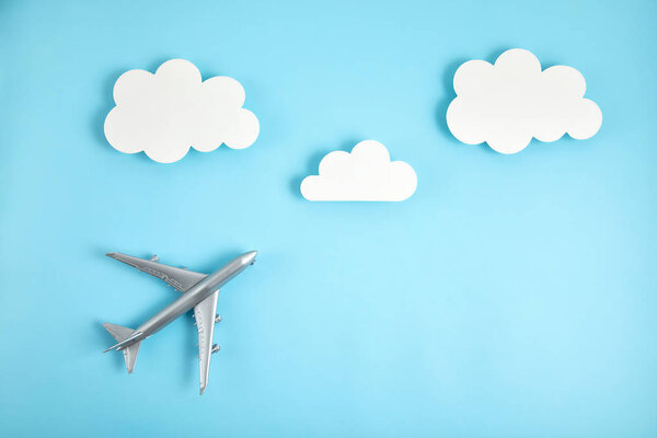 Miniature airplane. Travel tourism, airlines, low cost flights concept. Top view, flat lay.