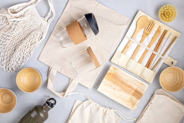 Zero waste kit. Set of eco friendly bamboo cutlery, mesh cotton bag, reusable coffee tumbler and water bottle. Sustainable, ethical, plastic free idea